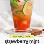 Front view of Non-Alcoholic Strawberry Mint Juleps on coasters with text overlay that reads "non-alcoholic Strawberry Mint Julep Mocktails: Fresh + Crisp + Lovely"