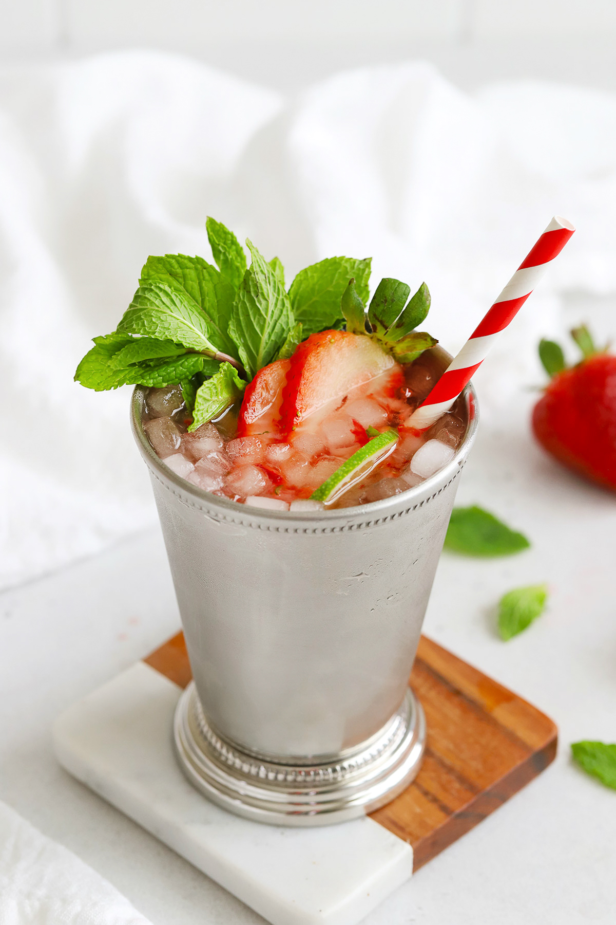 Front view of Non-Alcoholic Strawberry Mint Julep in a silver julep cup on a coaster