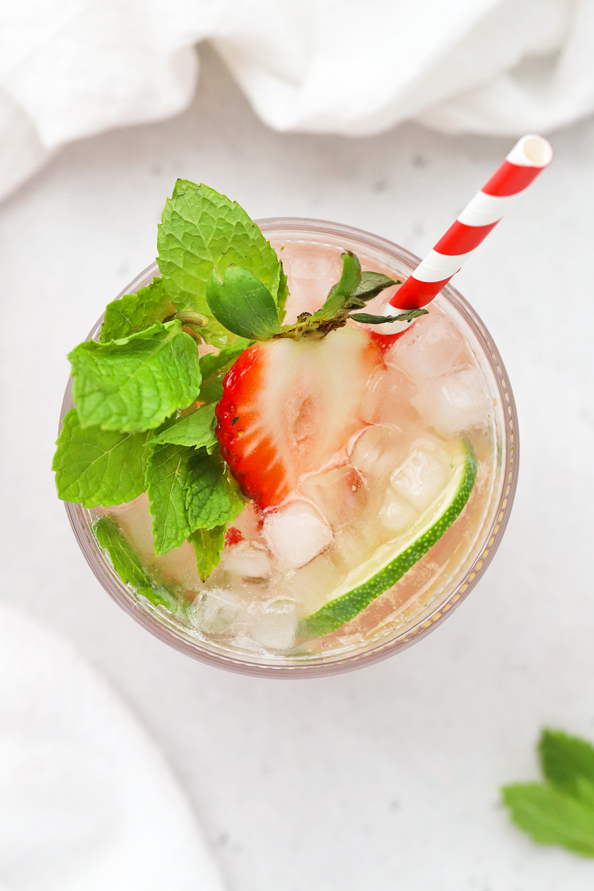 Overhead view of a non-alcoholic strawberry mint julep mocktail in a glass julep cup