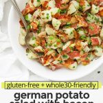 Overhead view of a white bowl of German Potato Salad with Bacon Dressing with text overlay that reads "gluten-free + whole30-friendly German Potato Salad with Bacon: You'll Love The Tangy Dressing!"