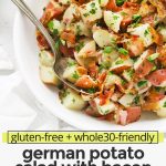 Overhead view of a white bowl of German Potato Salad with Bacon Dressing with text overlay that reads "gluten-free + whole30-friendly German Potato Salad with Bacon: You'll Love The Tangy Dressing!"