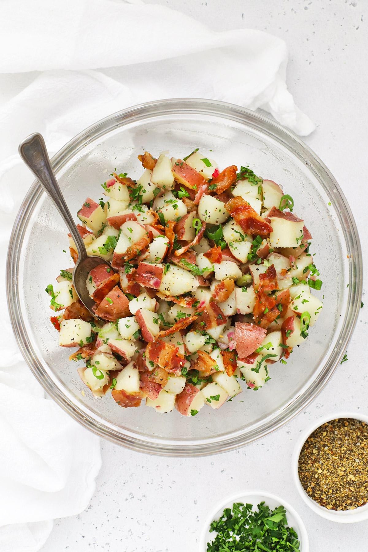 Overhead view of a glass bowl of German Potato Salad with Bacon Dressing