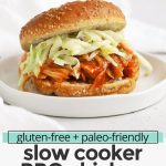 Front view of a slow cooker BBQ chicken sandwich on a white background with text overlay that reads " Paleo-Friendly Slow Cooker BBQ Chicken: Easy + Great For a Crowd!"