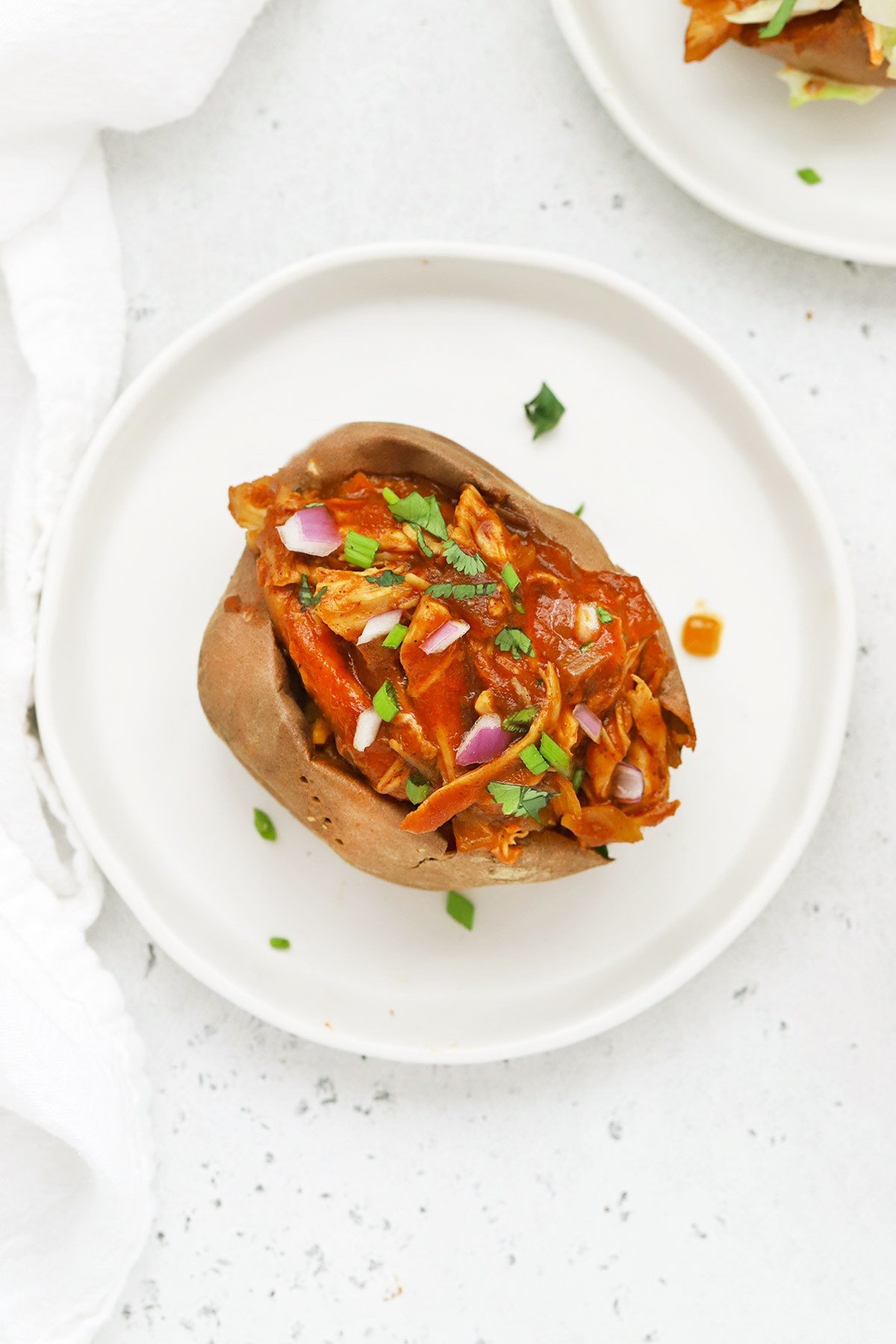 Overhead view of a sweet potato stuffed with Slow Cooker BBQ Chicken