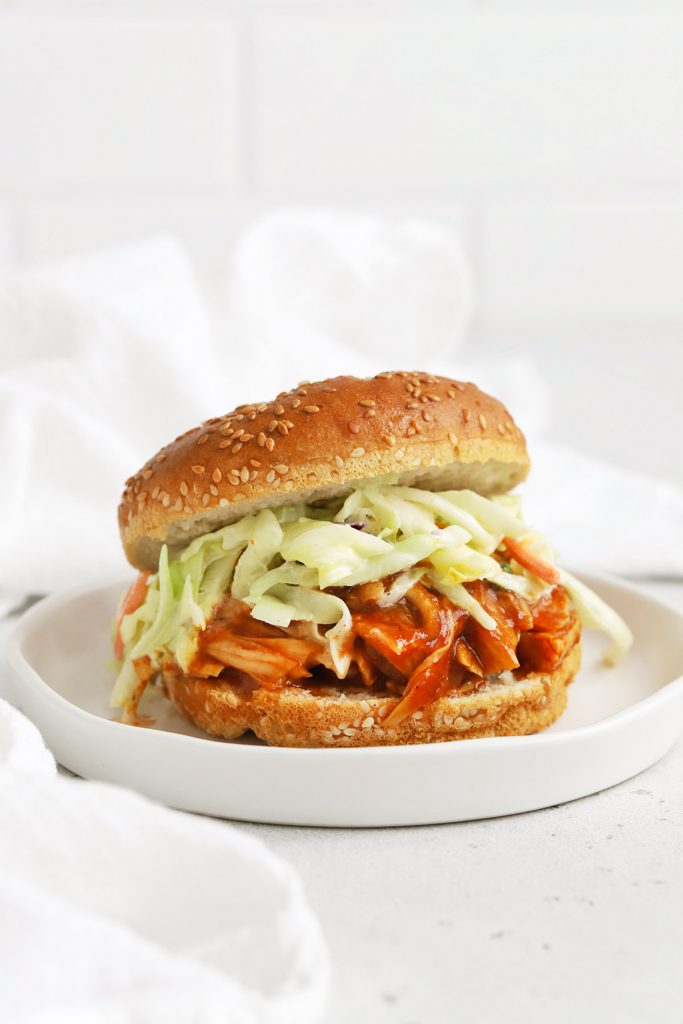 Front view of a slow cooker BBQ chicken sandwich on a white background
