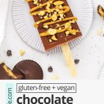 Overhead view of a chocolate peanut butter popsicle drizzled with natural peanut butter and sprinkled with crushed peanuts with text overlay that reads "gluten-free + vegan chocolate peanut butter popsicles: creamy + healthy + lovely"