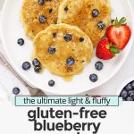 Overhead view of 3 fluffy gluten-free blueberry pancakes on a white plate drizzled with syrup with text overlay that reads "the ultimate light & fluffy gluten-free blueberry pancakes: dairy-free friendly + delicious"