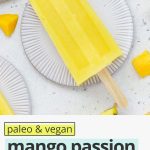 Overhead view of a mango passion fruit popsicle on a coaster with text overlay that reads paleo & vegan mango passion fruit popsicles: 3-ingredients + delicious"