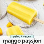 Front view of three mango passion fruit popsicles on coasters with text overlay that reads paleo & vegan mango passion fruit popsicles: 3-ingredients + healthy"