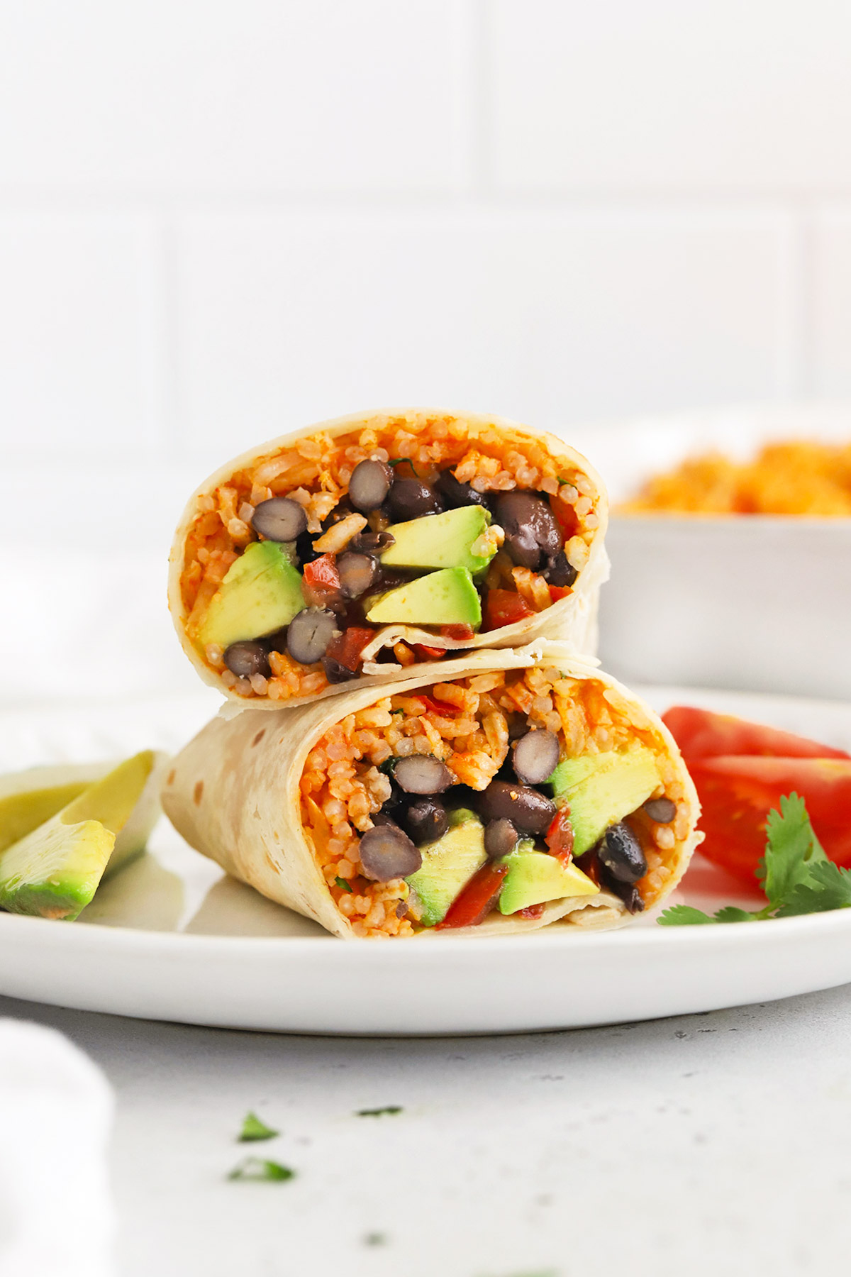 Front view of a vegan burrito with vegetarian Mexican Rice, black beans, avocado, and pico de gallo