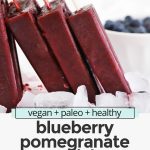 blueberry pomegranate popsicles on a white background