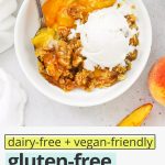 Overhead view of warm gluten-free peach crisp with a spoon in it, revealing colorful peach filling with text overlay that reads "dairy-free + vegan-friendly gluten-free peach crisp: try it with a scoop of ice cream!"