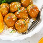 Close up view of healthy orange chicken meatballs with rice