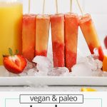 Side view of orange and red strawberry orange sunrise popsicles