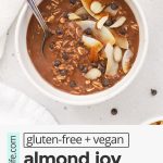 Overhead view of a bowl of almond joy overnight oats topped with chocolate and coconut with text overlay that reads "gluten-free + vegan almond joy overnight oats: an easy meal prep breakfast!"