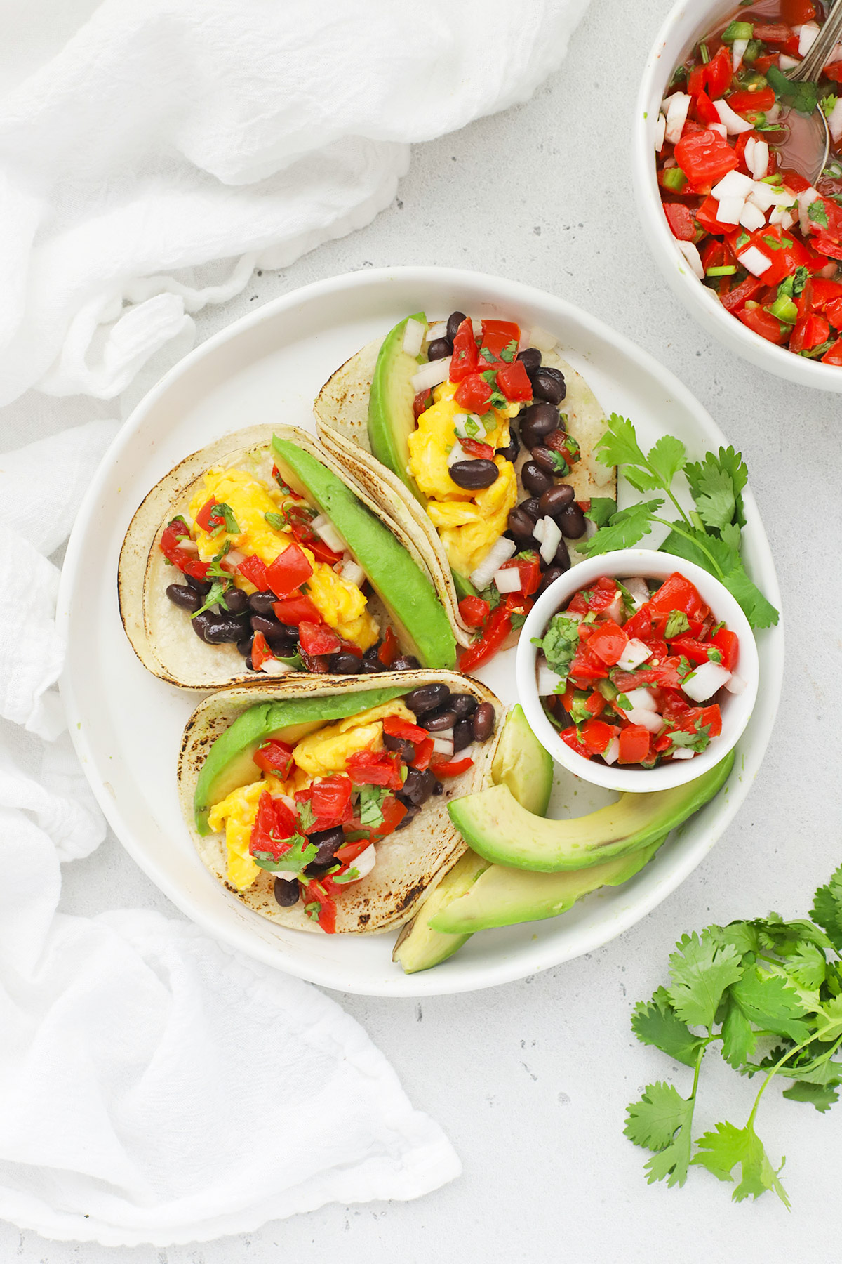 Overhead view of a platter of three healthy vegetarian breakfast tacos