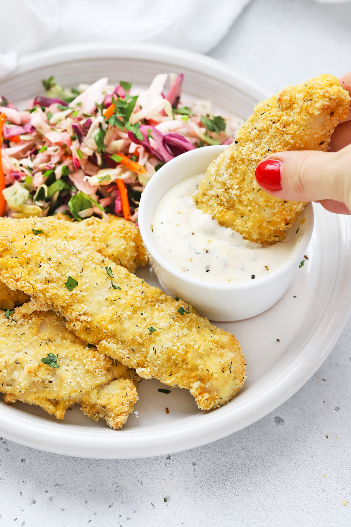 Paleo Almond Flour Chicken Tenders dipped in paleo ranch