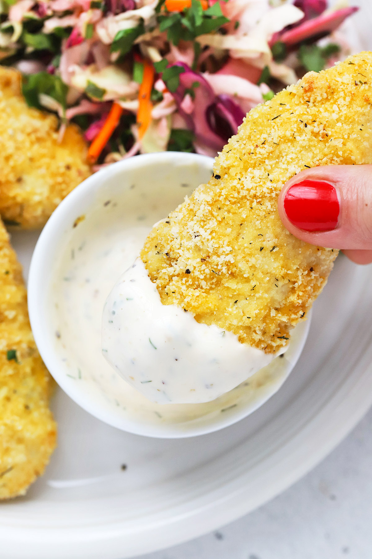 Paleo Almond Flour Chicken Tenders dipped in paleo ranch