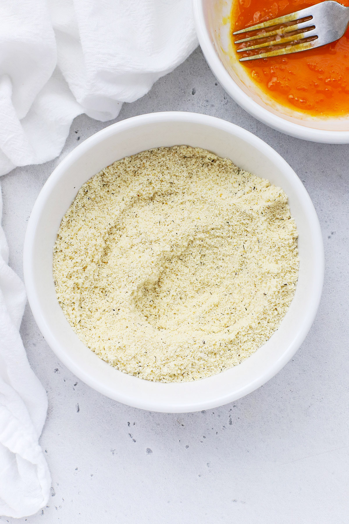 Seasoned almond flour and egg wash for paleo almond flour chicken tenders