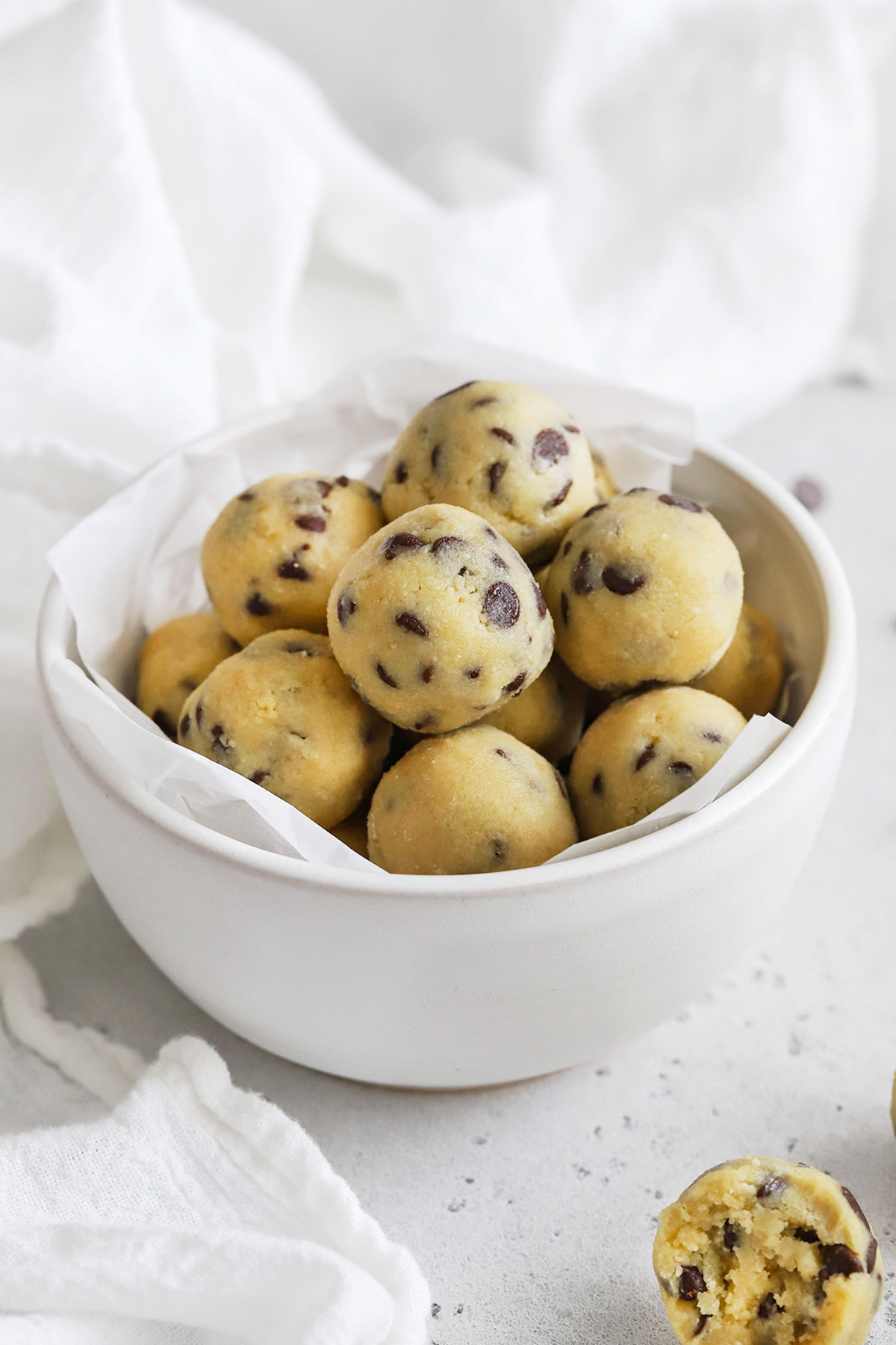Front view of a bowl of healthy edible cookie dough bites with chocolate chips