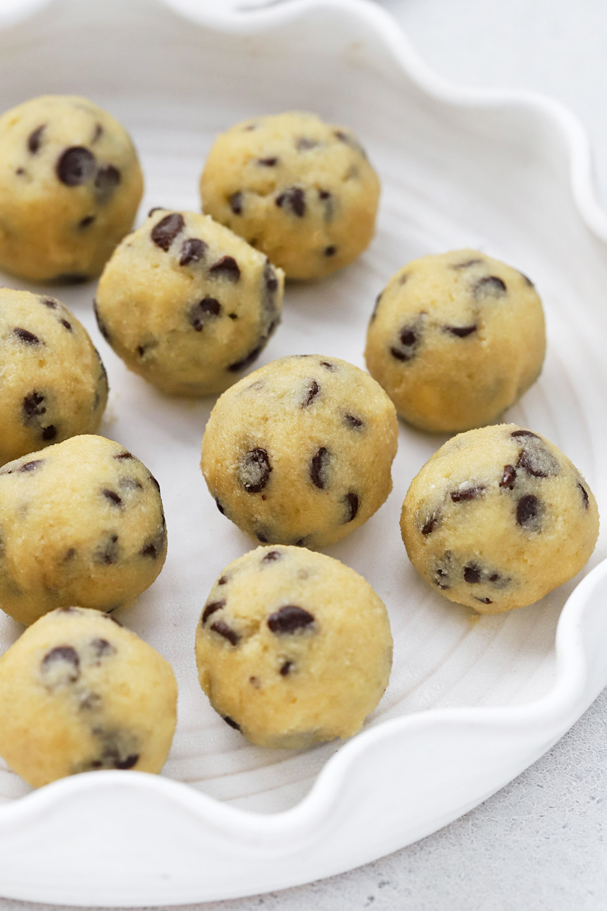 Front view of a plate of healthy edible cookie dough bites