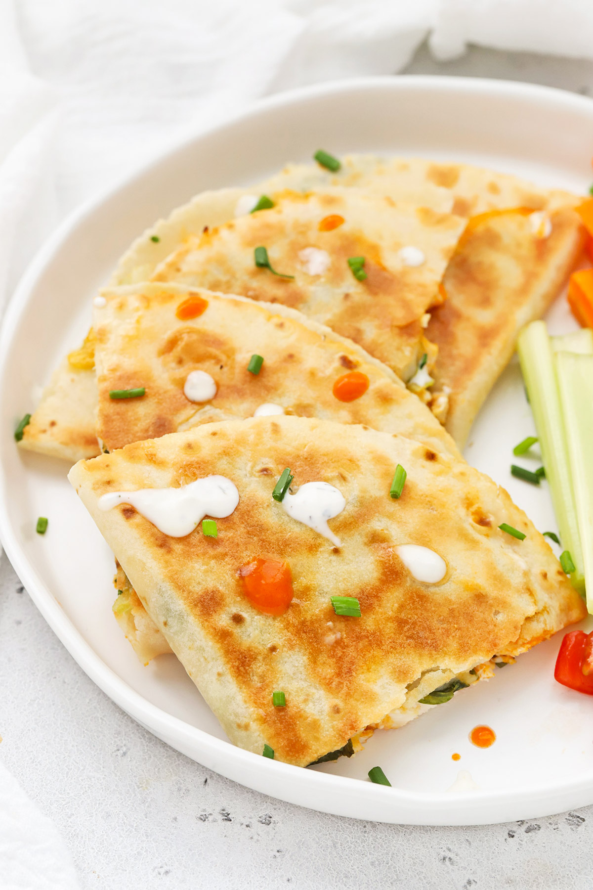 Front view of buffalo chicken quesadillas cut into quarters