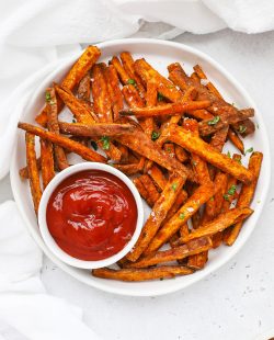 Overhead view of crispy baked sweet potato fries served with ketchup