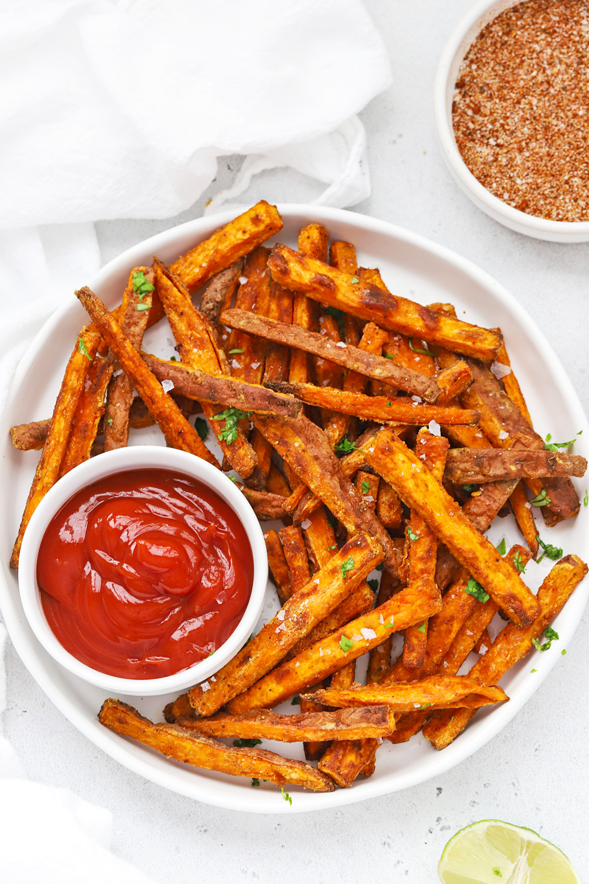 Overhead view of crispy baked sweet potato fries served with ketchup