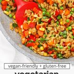 Close up Overhead view of a pan of healthy vegetarian fried rice with colorful veggies with text overlay that reads "gluten-free + vegan-friendly vegetarian fried rice: quick + easy + healthy"