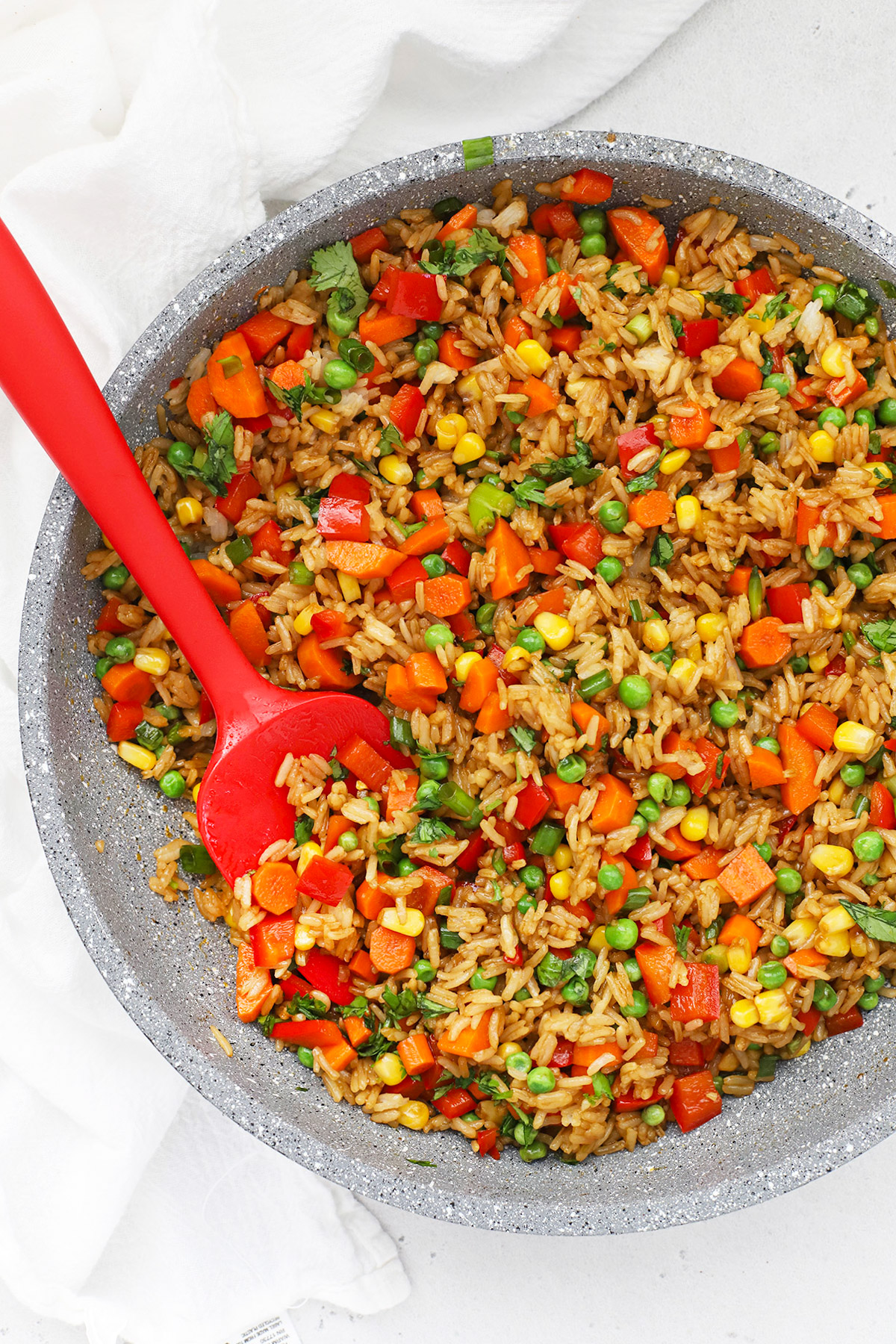 Overhead view of a pan of healthy vegetarian fried rice with colorful veggies