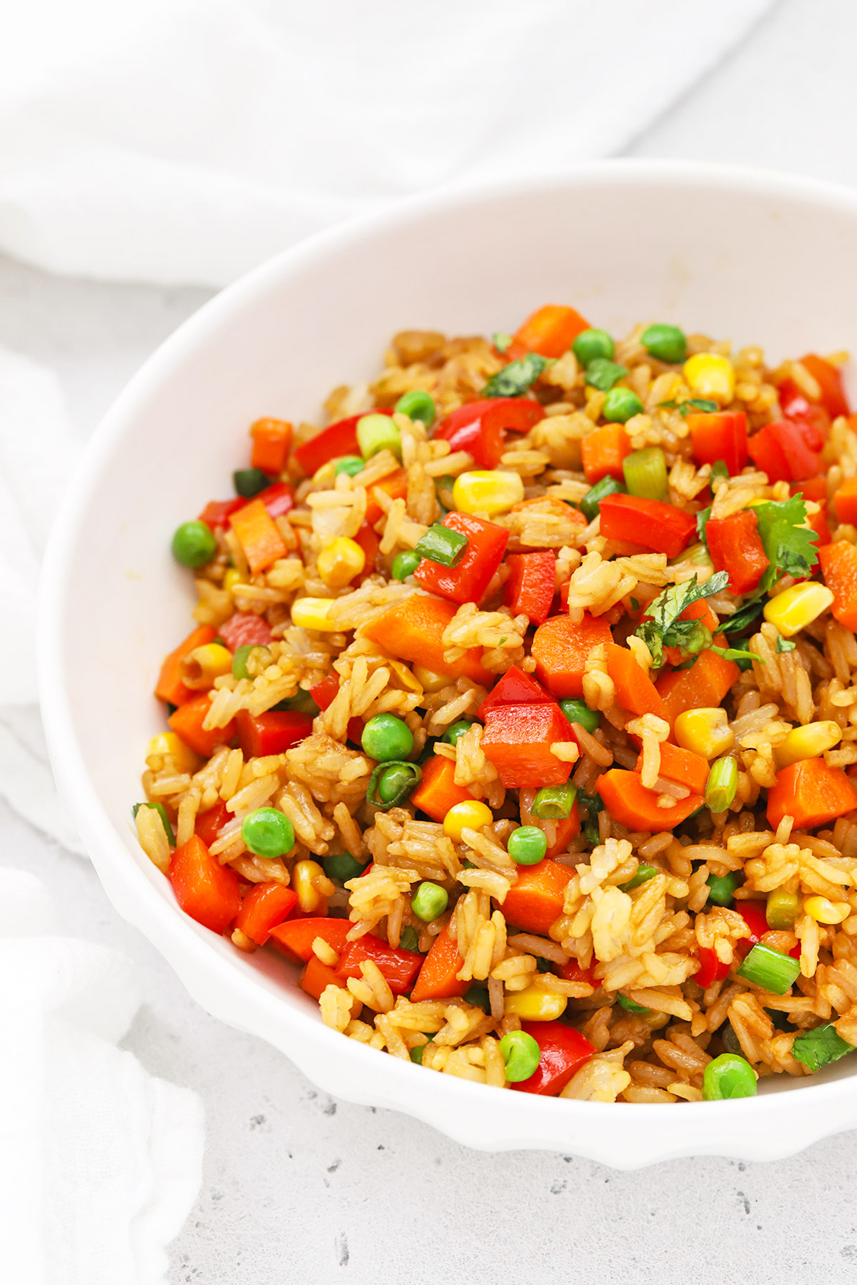 Front view of a serving bowl of healthy vegetarian fried rice with colorful veggies