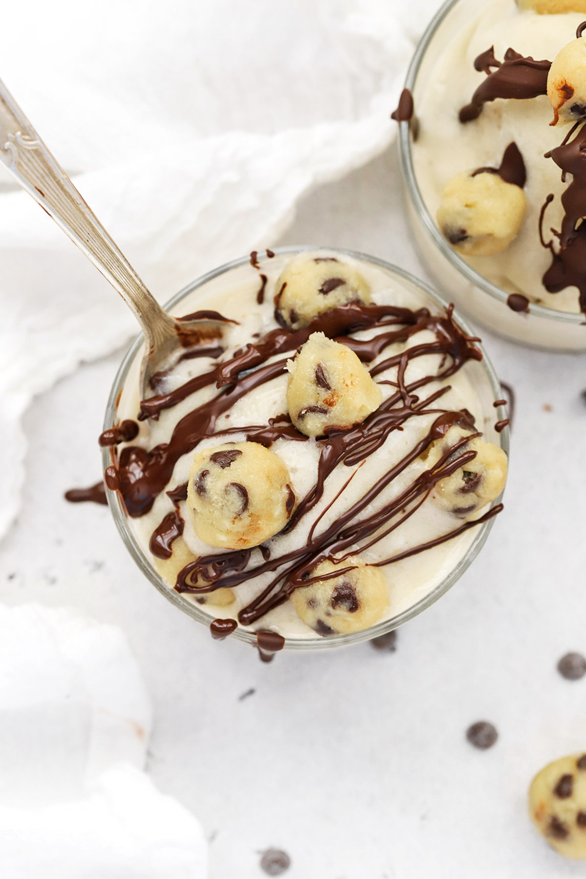 Overhead view of creamy healthy cookie dough nice cream covered with drizzled chocolate sauce
