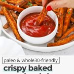 Crispy baked sweet potato fries on a white plate with a small bowl of ketchup