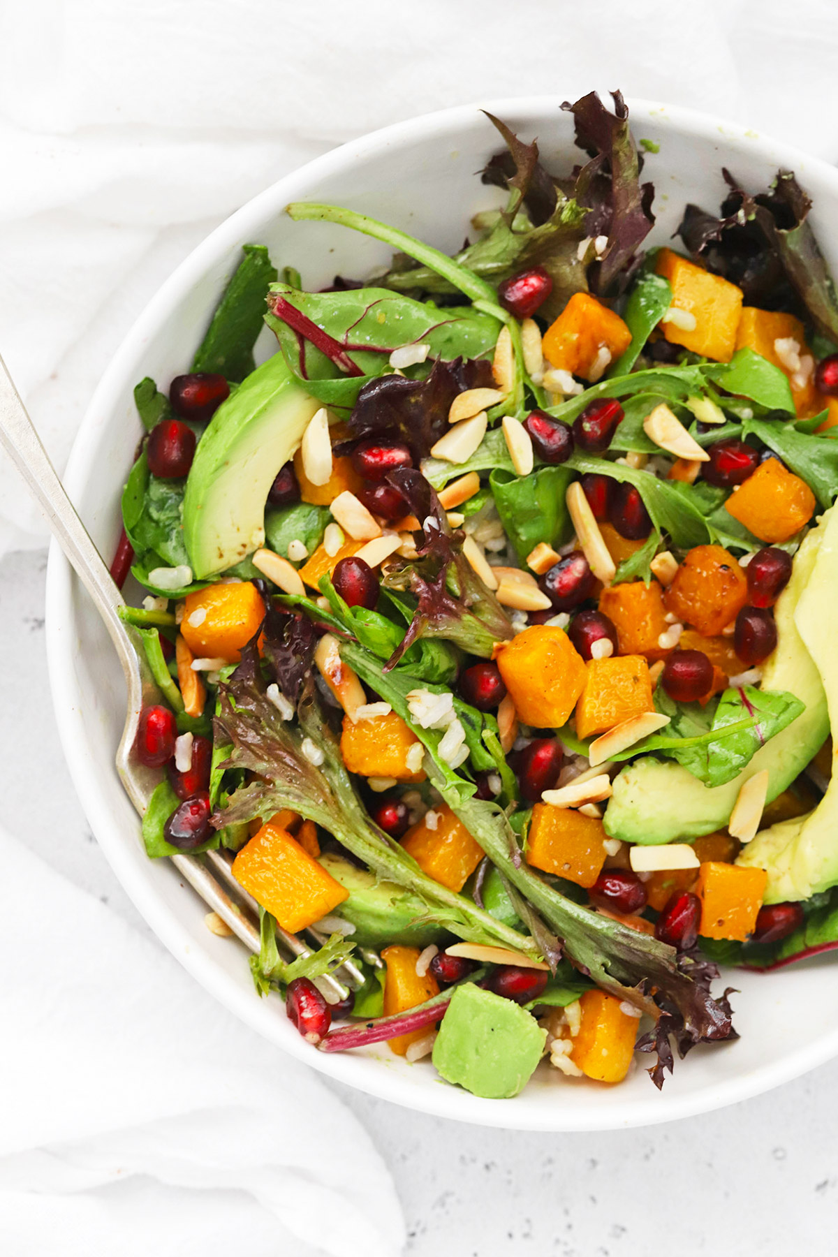 Overhead view of winter butternut squash pomegranate salad with cider vinaigrette