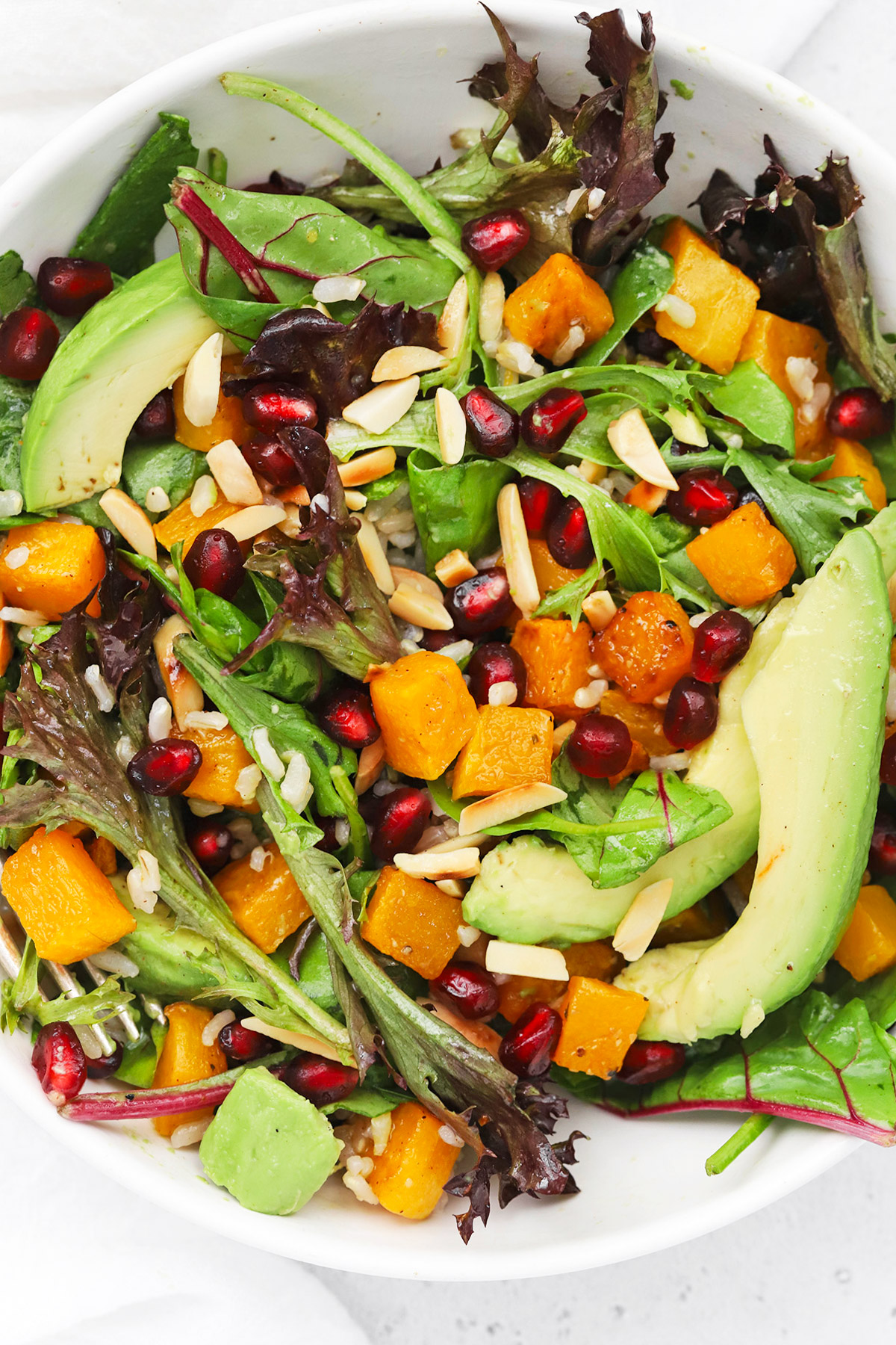 Overhead view of winter butternut squash pomegranate salad with cider vinaigrette