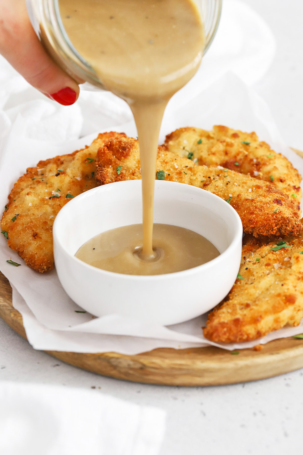 Crispy gluten-free chicken tenders served with One Lovely Life's honey mustard dipping sauce