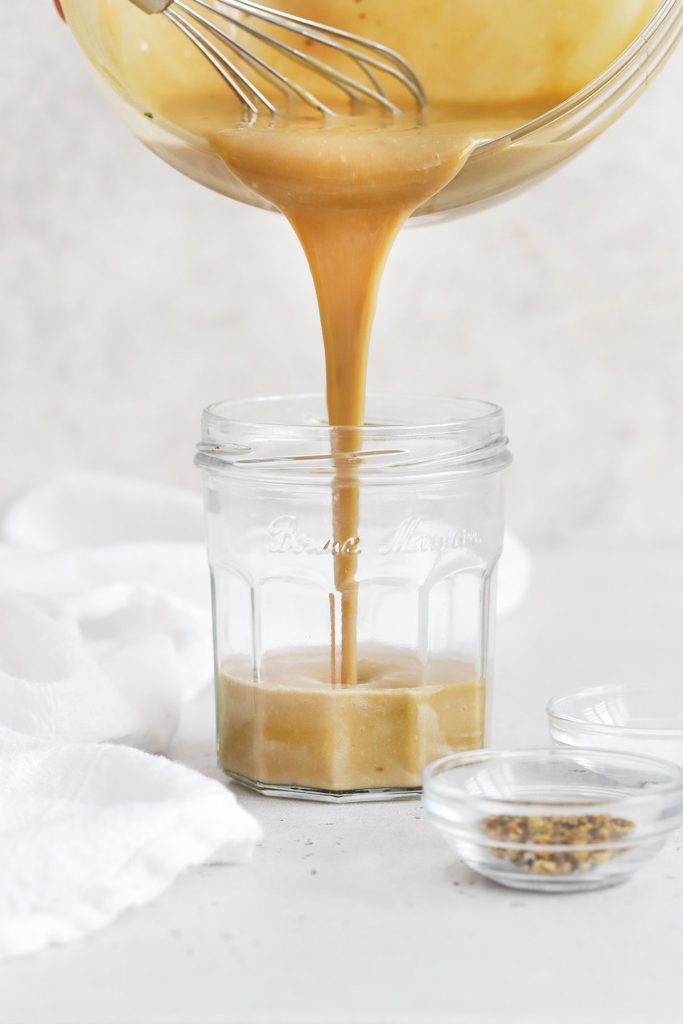 Pouring honey mustard dressing into a jar