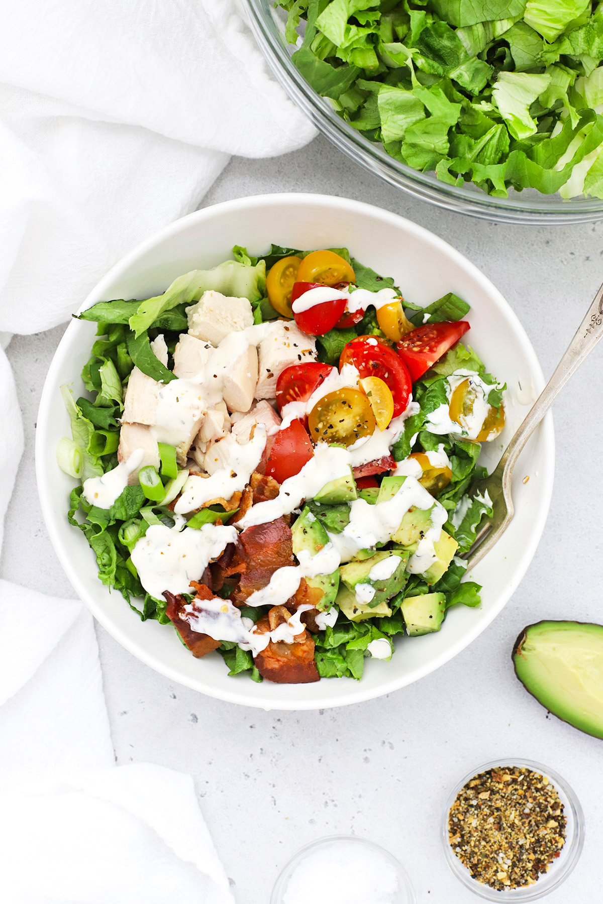 Overhead view of a bowl of chicken bacon avocado salad with ranch