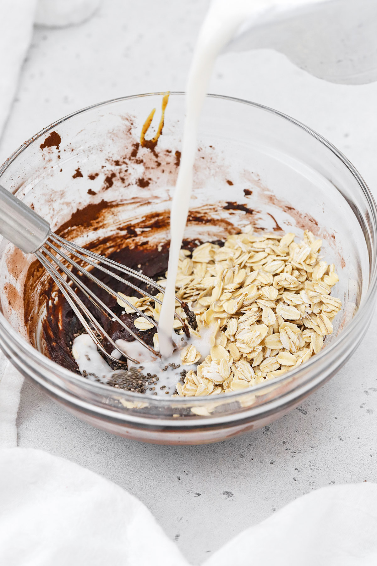 Whisking in milk to make chocolate peanut butter overnight oats