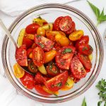 Overhead view of balsamic marinated tomato salad with herbs