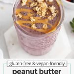 purple smoothie drizzled with peanut butter and sprinkled with granola
