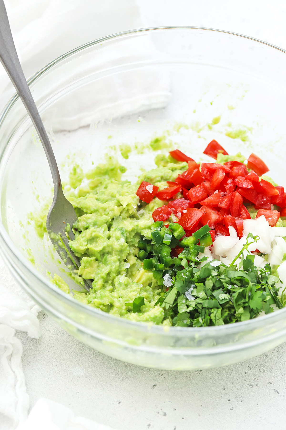 Overhead view of classic guacamole with tomatoes & jalapeño