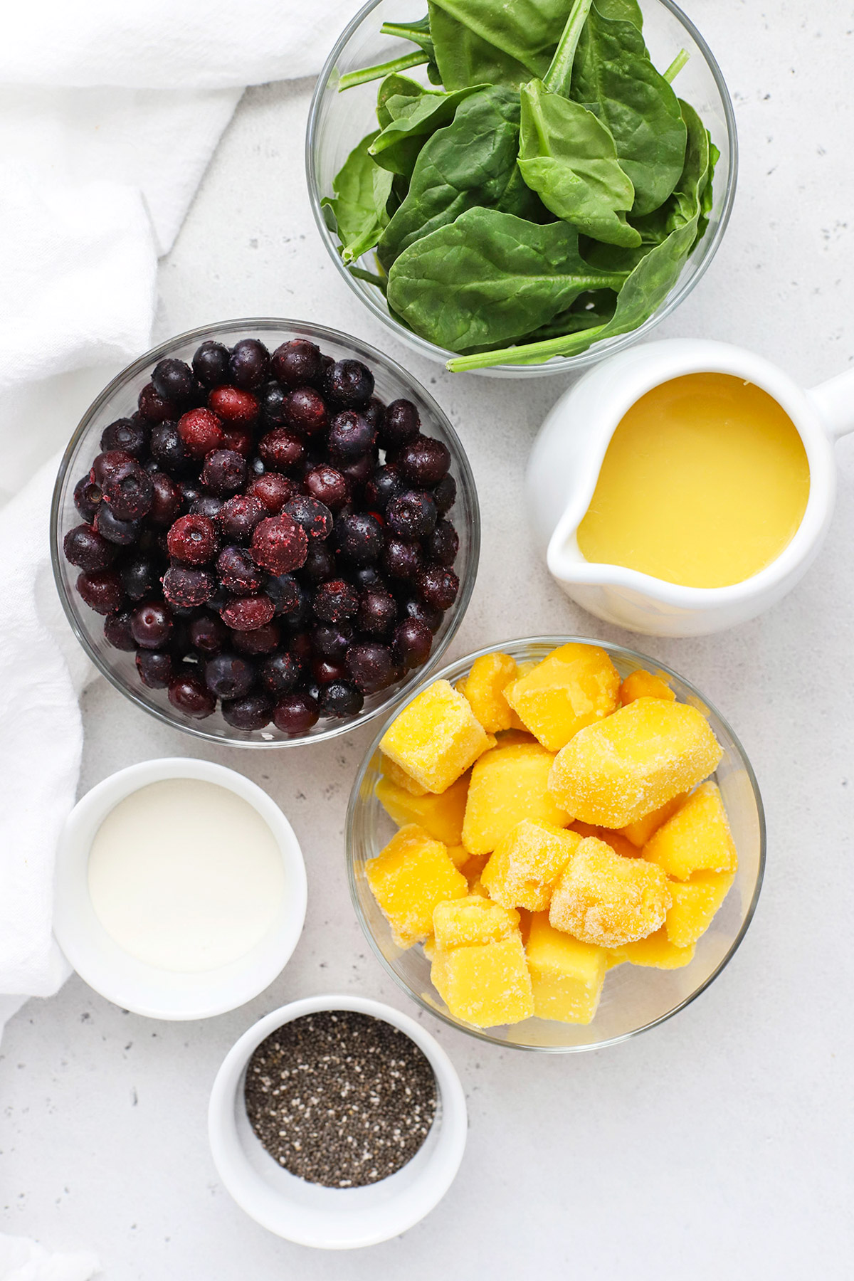 Overhead view of ingredients for blueberry mango smoothies