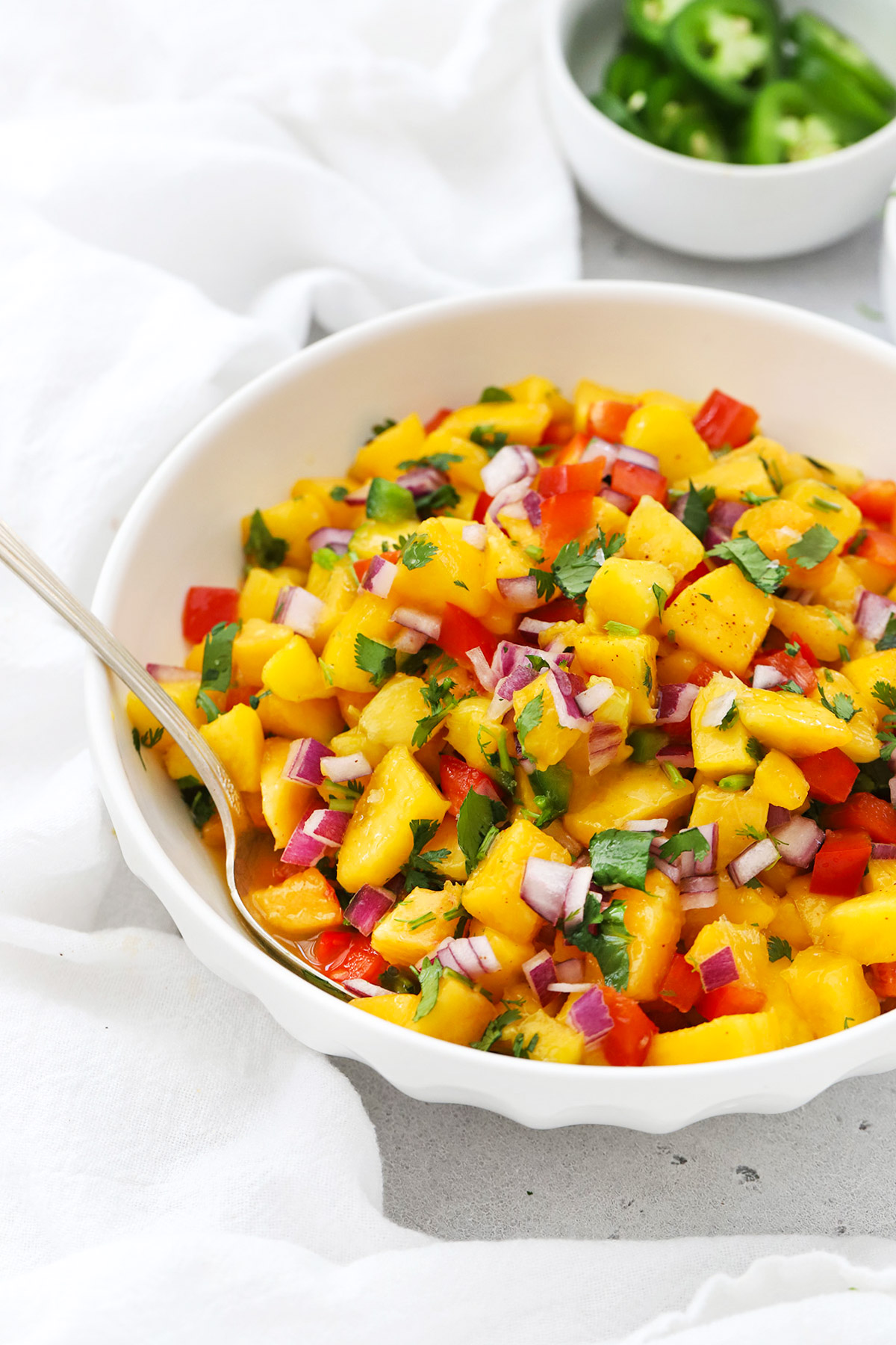 Front view of a bowl of fresh peach salsa