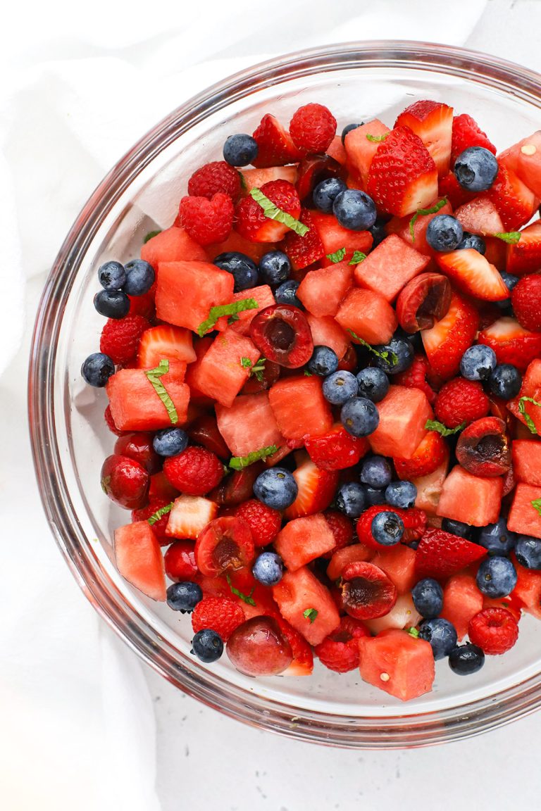 Overhead view of a bowl of watermelon berry fruit salad with fresh mint lime dressing