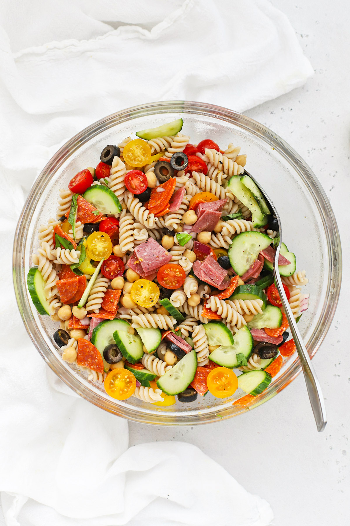 Overhead view of a large bowl of gluten-free pasta salad with Italian dressing
