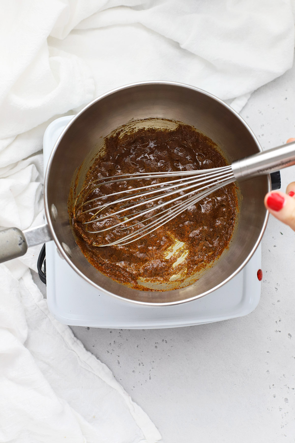 Stirring spices and roux for gluten-free enchilada sauce