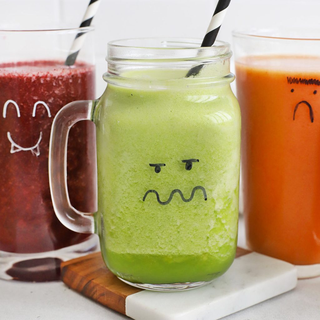 front view of three colorful smoothies with monster faces