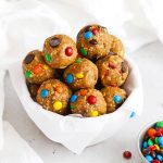 Front view of a bowl of monster cookie energy bites with mini m&ms