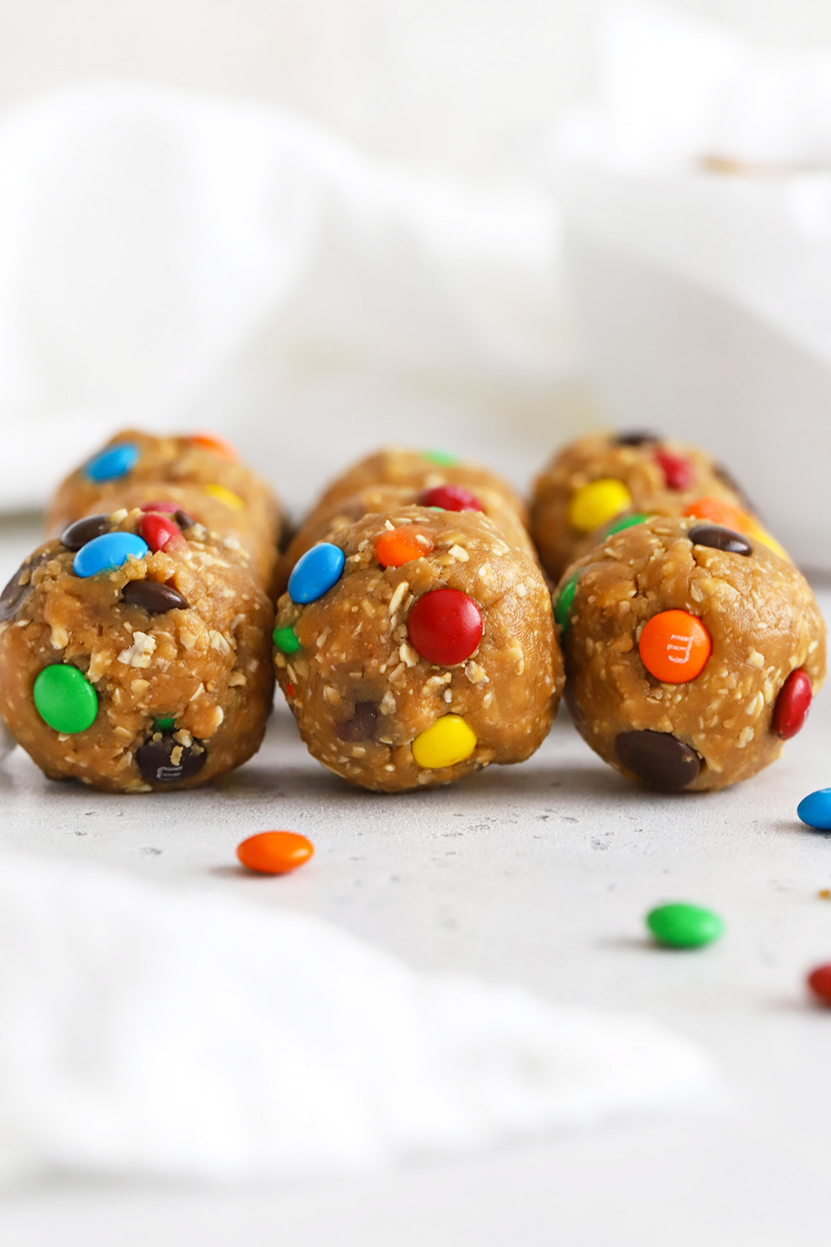 front view of monster cookie energy bites on a white background